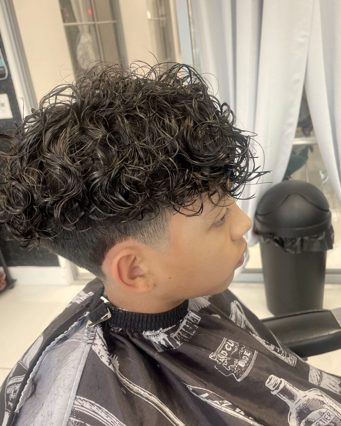 Curly top with a clean taper