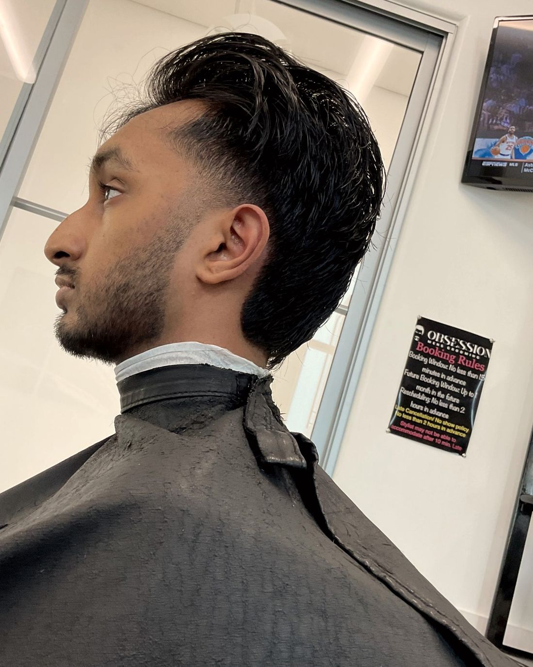 Swept-back cut with a trimmed beard