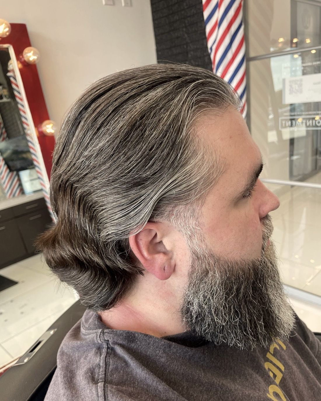 Long grey hair with a shaped full beard